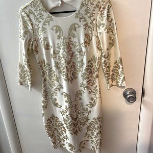 White and gold sequin cock tail dress, half sleeve, open back.